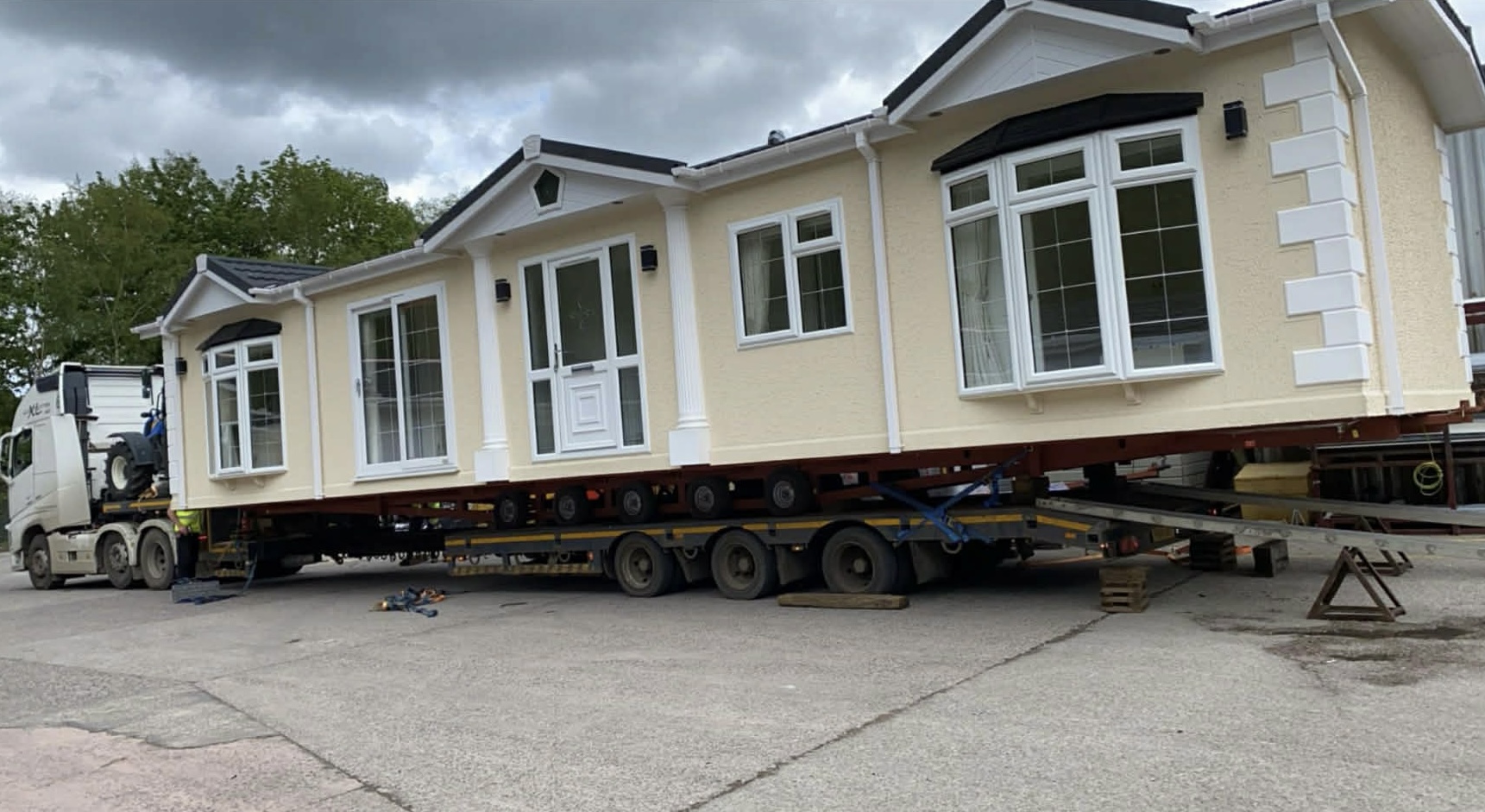 Luxury cream modular park home on heavy flatbed transport truck